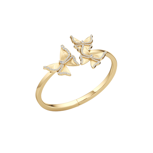 Gold ring with butterfly designs on a white background