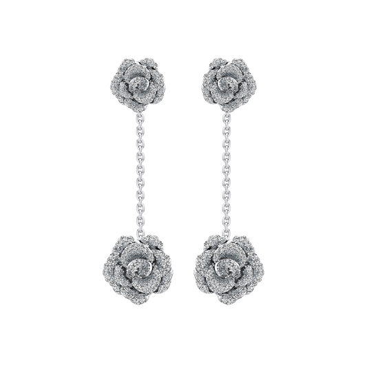 Silver rose-shaped earrings with chains on a white background