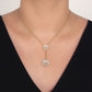 Gold necklace with floral pendants on a person wearing a black top.