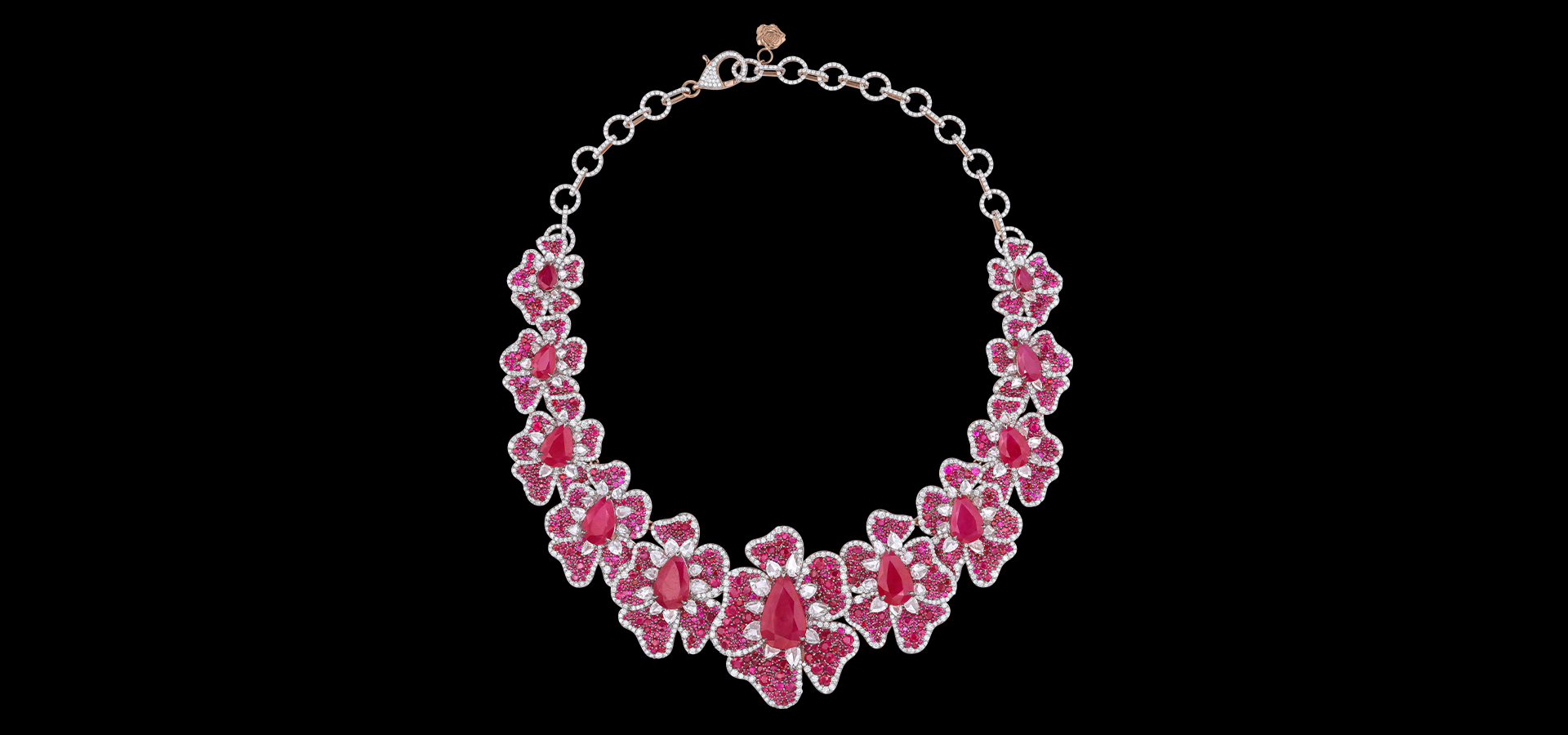 Bracelet with pink gemstones and silver chain on a black background