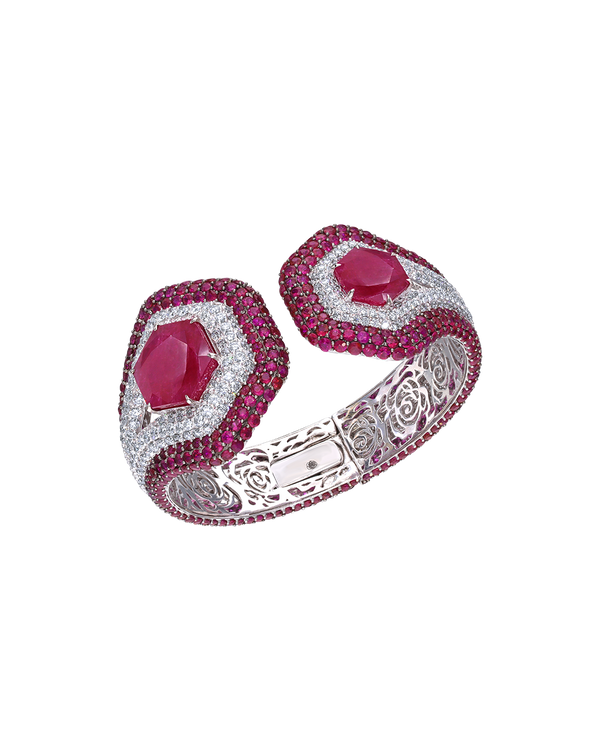 Ornate bracelet with pink gemstones and silver detailing on a white background