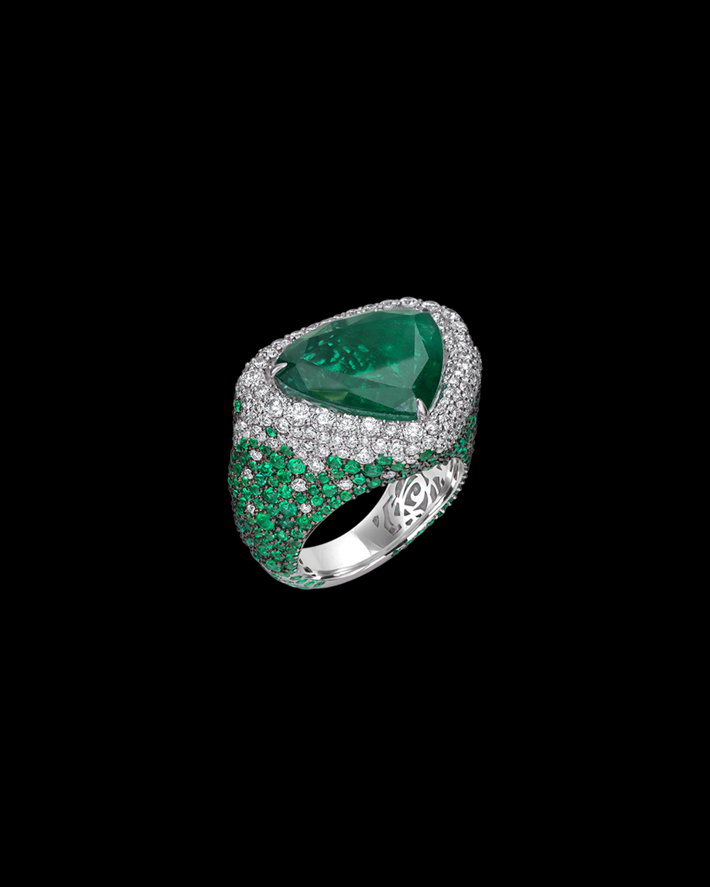 Luxury emerald ring with intricate design on a black background