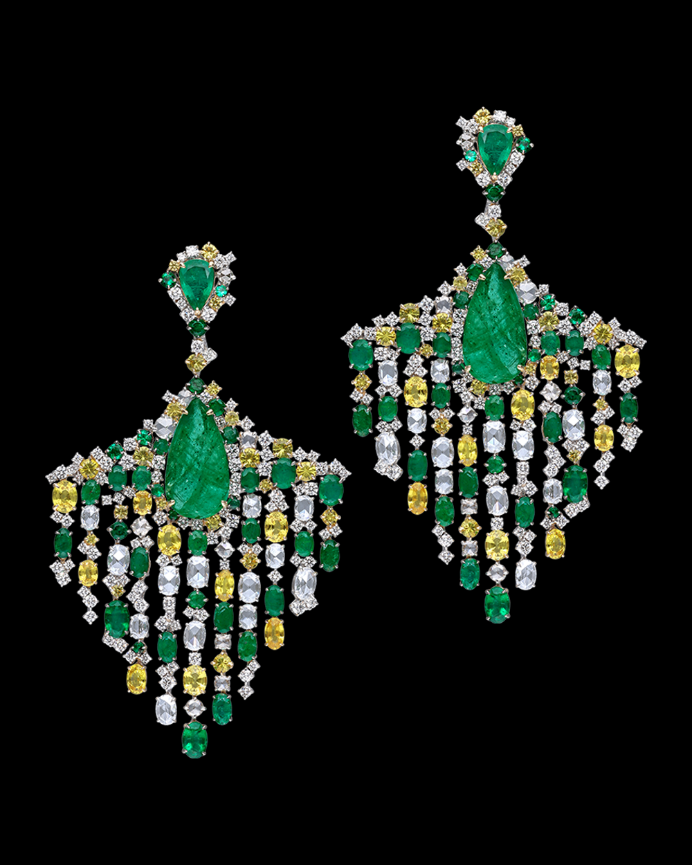 Pair of chandelier earrings with green, yellow, and clear gemstones on a black background
