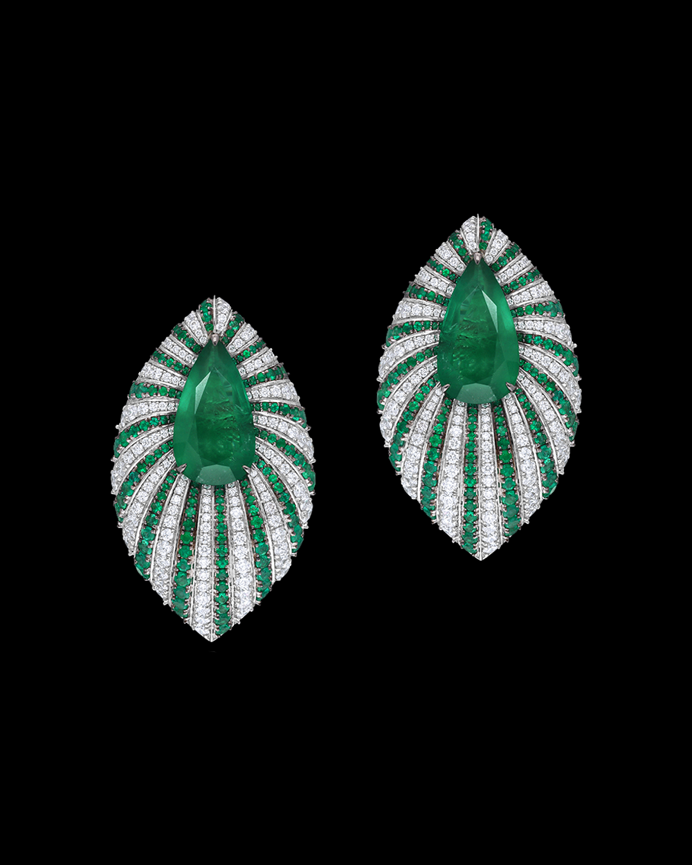 Pair of emerald and diamond earrings on a black background